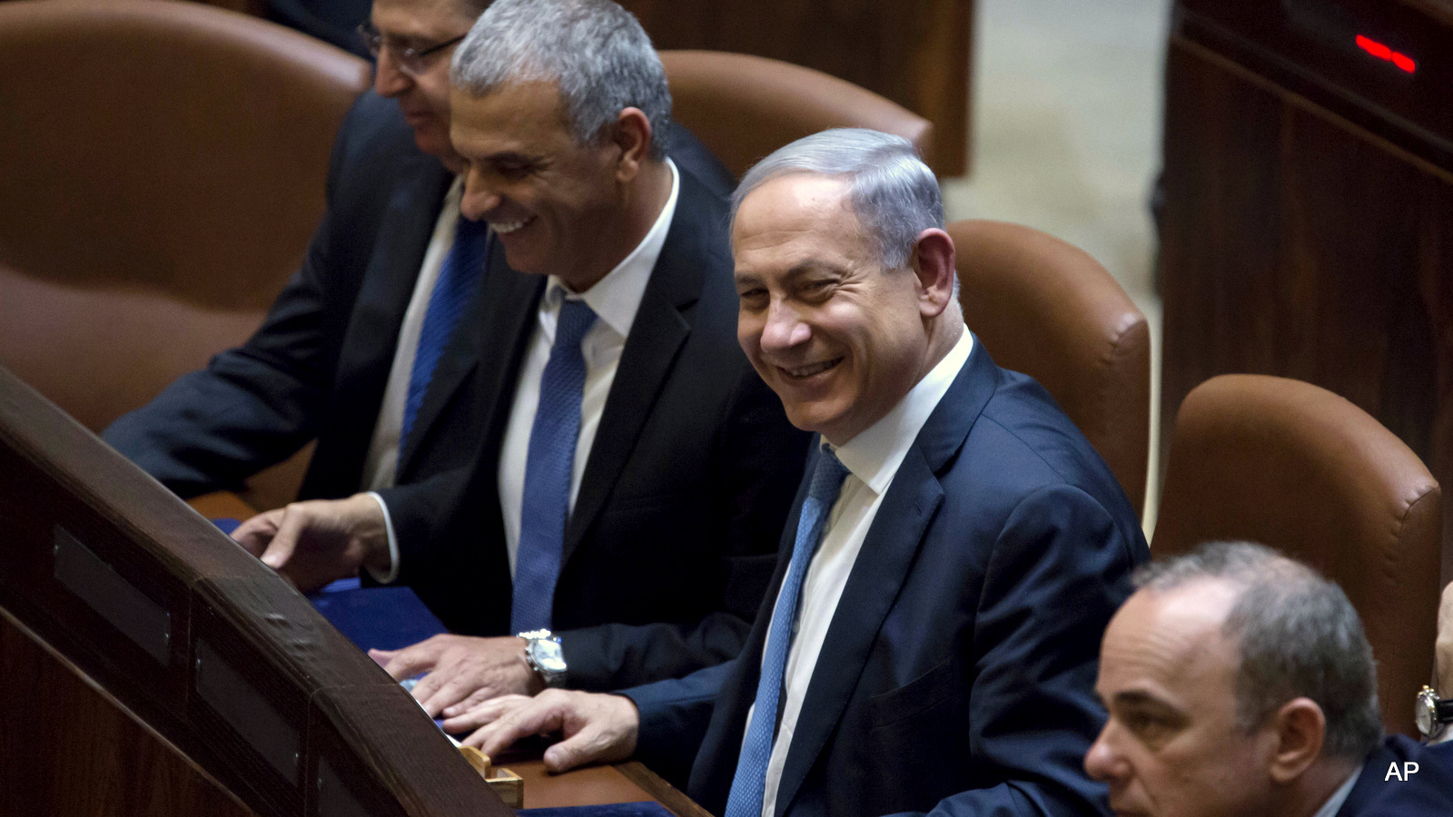Israeli Prime Minister Benjamin Netanyahu, second right, heads the new government as ministers take their place including Defense Minister Moshe Ya'alon, left, and Moshe Kahlon, Housing Minister, second left, as the prime minister fills cabinet posts at the last minute forming the 34th government of Israel, two months after the mid-March general elections.