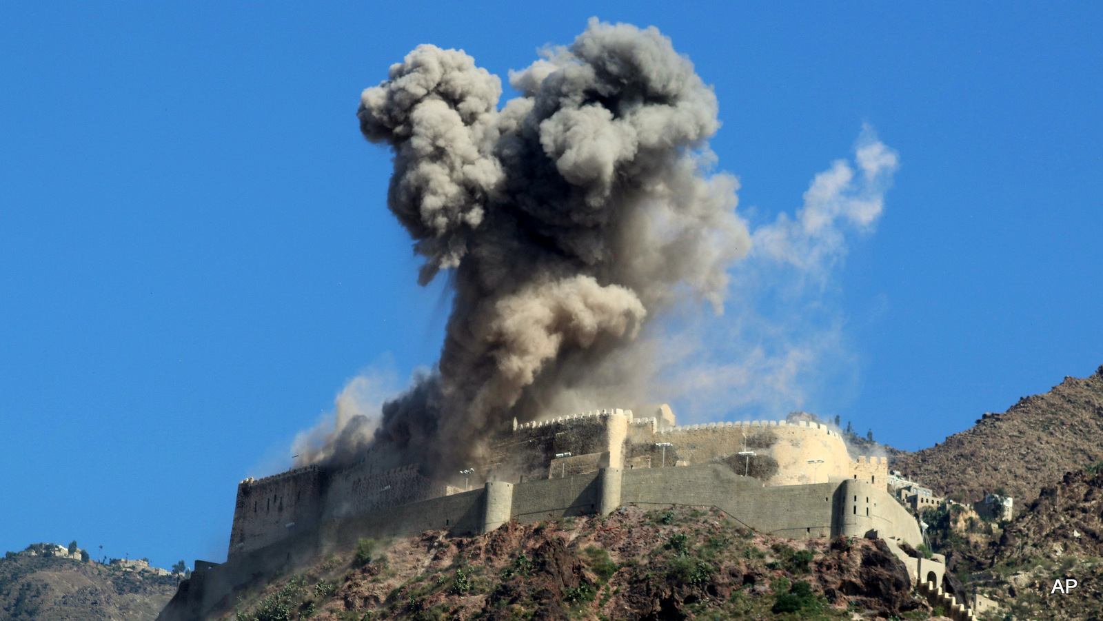 Smoke rises from Al-Qahira castle following a Saudi-led airstrike in Taiz city, Yemen, Tuesday, May 12, 2015. Warplanes from a Saudi-led coalition kept up their airstrikes in Yemen on Tuesday, targeting the positions of Shiite rebels and their allies just hours ahead of the scheduled start of a five-day humanitarian cease-