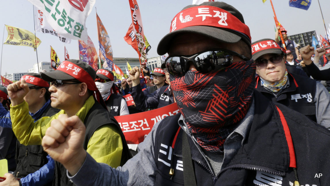 Members of the Federation of Korean Trade Unions shout slogans during a May Day rally near the National Assembly in Seoul, South Korea, Friday, May 1, 2015.