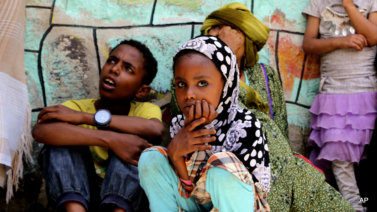 Saturday, May 9, 2015. Displaced families who fled fighting in the southern city of Aden wait for relief supplies during a food distribution effort by Yemeni volunteers, in Taiz, Yemen. Humanitarian organizations say they face challenges delivering aid to citizens affected by the ongoing conflict, because of a Saudi blockade on Yemen, which receives 90% of it's food from overseas.