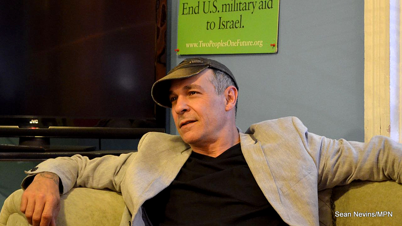 Doug, 51, a photographer, looks on as John Kiriakou, former CIA analyst and operations officer, talks at Code Pink’s Pink House in Washington DC on May 20.