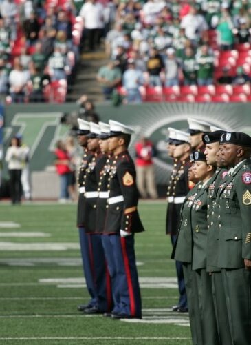 Marine Corps, Air Force, Navy, Coast Guard and Army service members salute during a ceremony at Giants stadium before the New York Jets game against the Jacksonville Jaguars. (Photo: Marine Corps/Sgt. Randall A. Clinton/public domain)