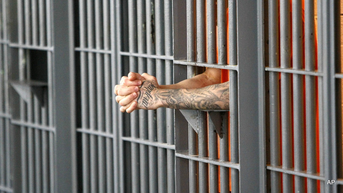 An inmate stands at his cell door at the maximum security facility at the Arizona