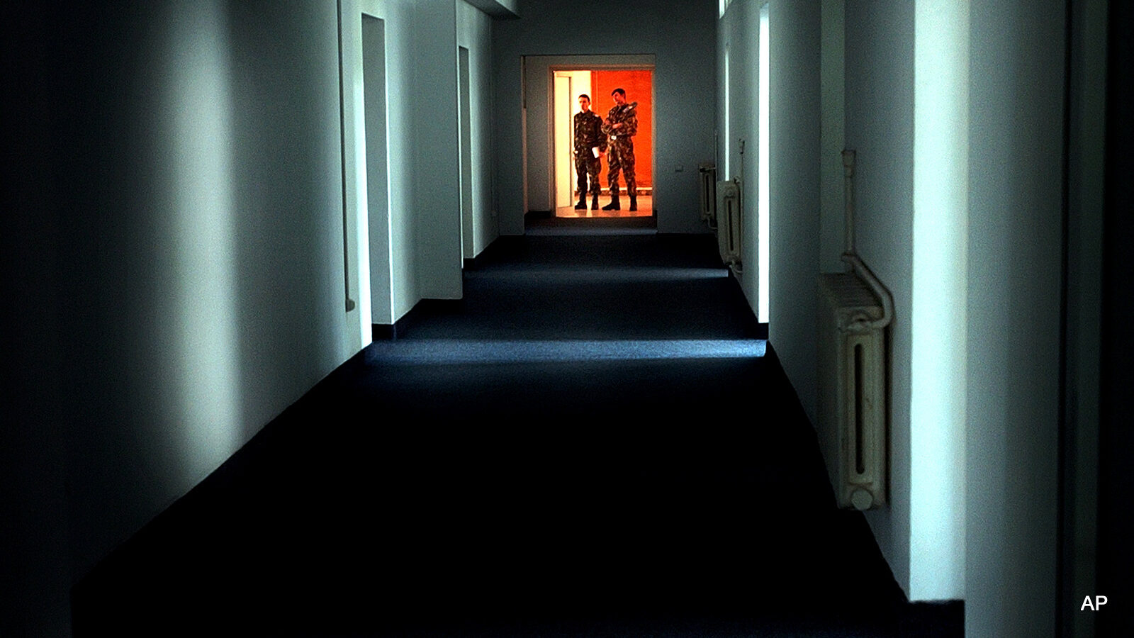 Romanian military staff stands at the end of a corridor on the Mihail Kogalniceanu Air Base, some 250 kilometers east of Bucharest, in this Nov. 9 2005 file photo. Establishing the exact nature of Romania's involvement in a suspected secret U.S. program is crucial to building the case that Washington sidestepped international human rights conventions by persuading allies to perform dirty work on terror suspects that would have otherwise been illegal in the United States.