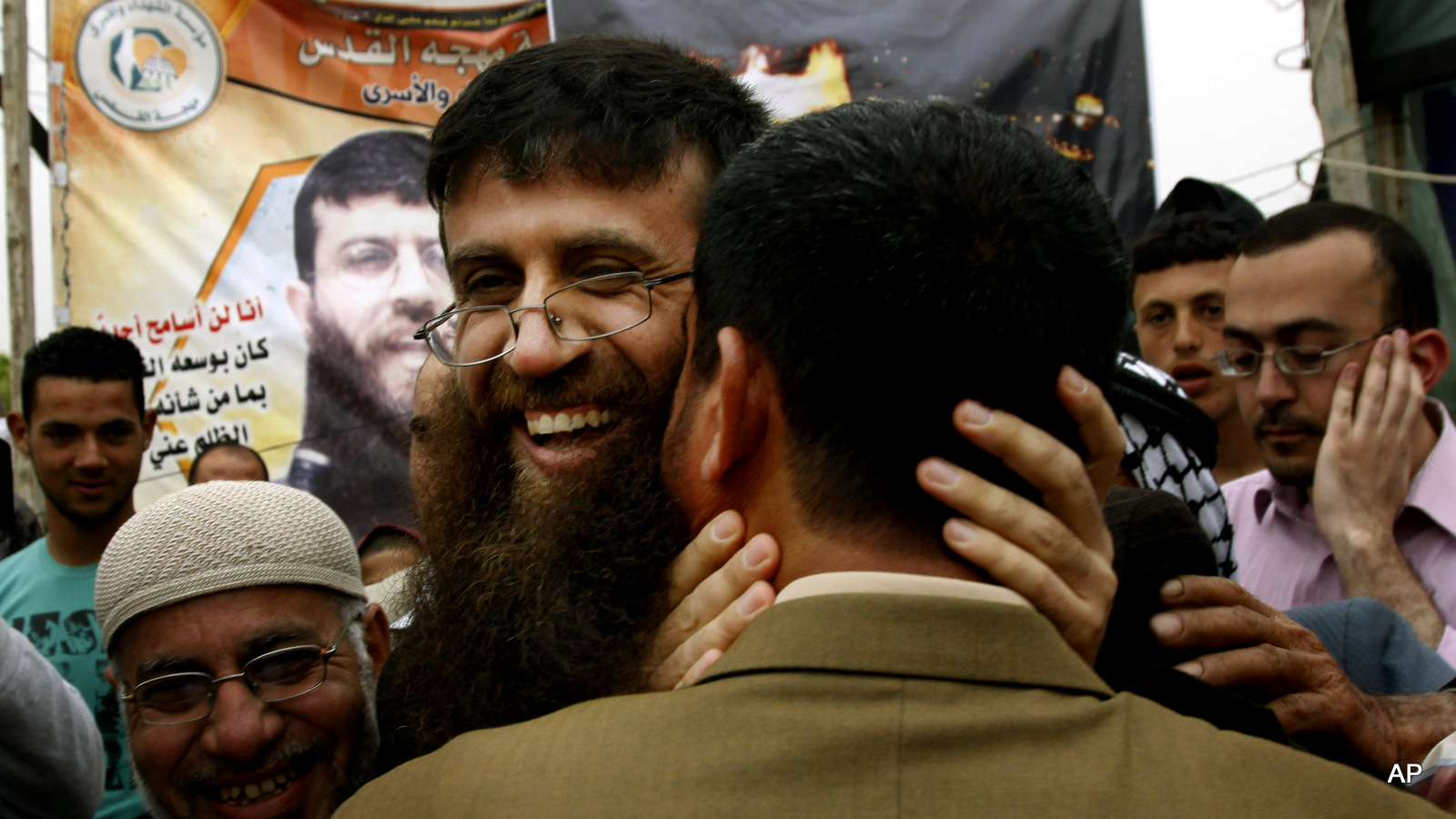 Palestinian Khader Adnan, center, is greeted by Palestinians during a celebration ceremony after his release from Israeli jails, in the West Bank village of Arrabeh, near Jenin, Wednesday, April 18, 2012.