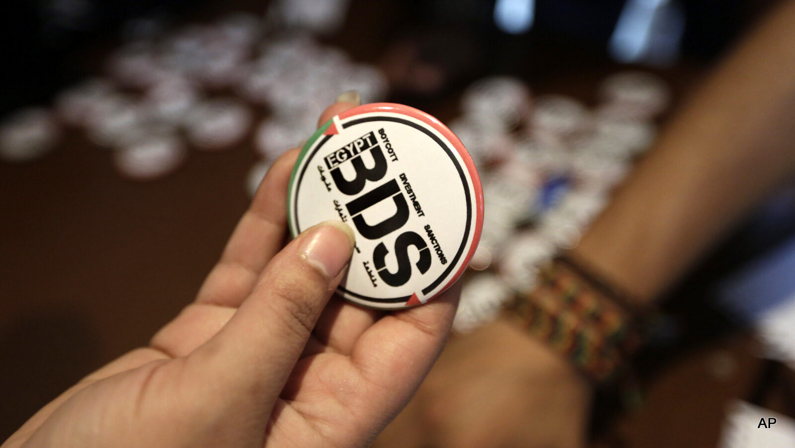 a pin with the Boycott, Divestment and Sanctions (BDS) logo