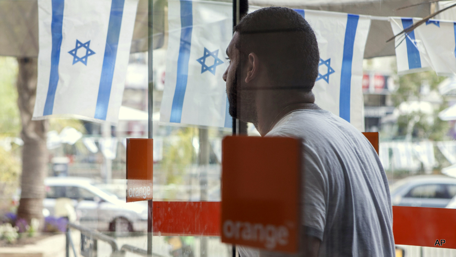 An Israeli man walks out from the "Partner Orange" Communications Company's offices in the city of Rosh Haain, Israel