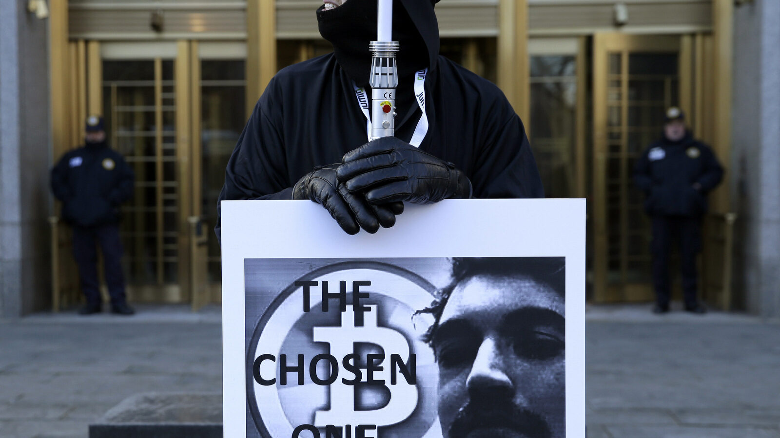 Supporters of Ross William Ulbricht hold signs during the jury selection for his trial