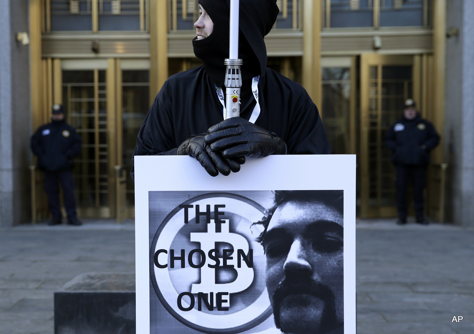 Supporters of Ross William Ulbricht hold signs during the jury selection for his trial