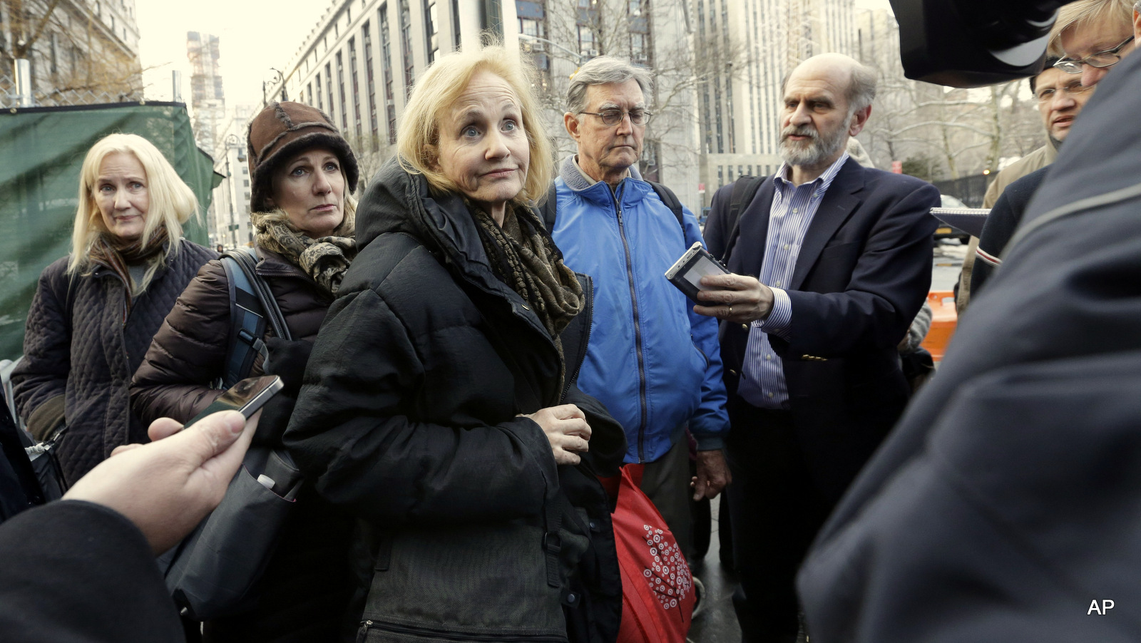 Lyn, center, and Kirk Ulbricht, fourth from left,  parents of Ross William Ulbricht, speak to reporters outside Manhattan Federal cour
