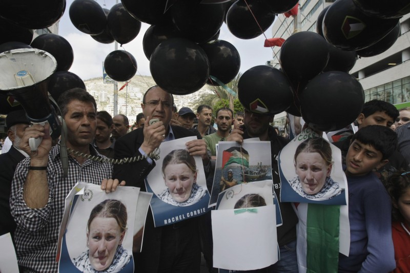 Palestinians hold photographs of American peace activist Rachel Corrie as they mark the tenth anniversary of her death in Nablus in the West Bank, March 16, 2013. Corrie was killed by an Israeli army bulldozer in the Gaza Strip in 2003 while she and other activists tried to prevent the demolition of a home. (AP/Nasser Ishtayeh)