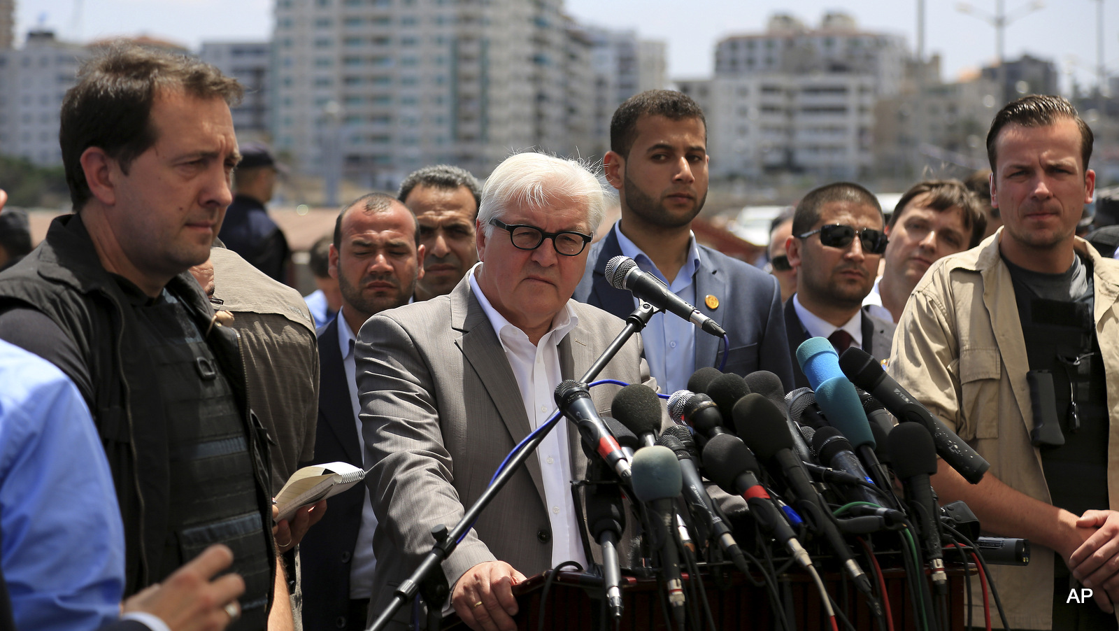 Germany's Foreign Minister Frank-Walter Steinmeier, centre, talks during a press conference at fishermen's port in Gaza City, northern Gaza Strip, Monday, June 1, 2015. Steinmeier paid a rare visit to the Hamas-ruled Gaza Strip on Monday, calling on Israel to ease a blockade on the territory and urging Hamas prevent rockets from being fired into Israel. 