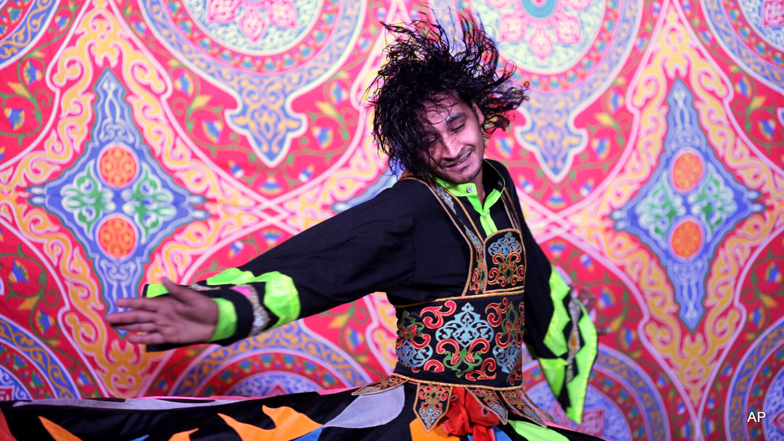whirling dervish Mahmoud Rizk, spins during a performance held by the Al-Tannoura Egyptian Heritage Dance Troupe, at the Darb 1718 cultural center, in Cairo, Egypt.