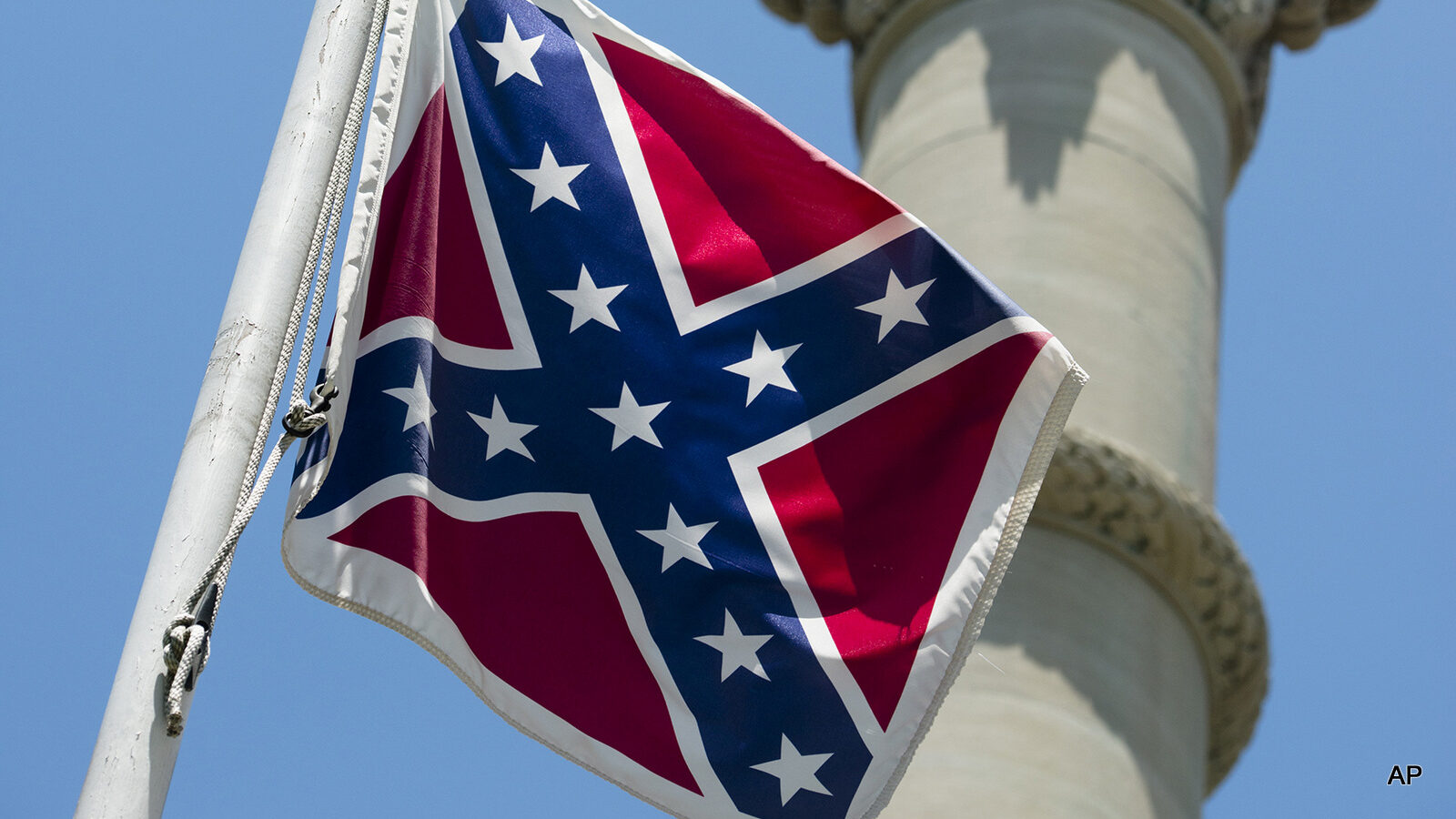 A Confederate flag flies next to the Alabama Confederate Memorial on the grounds of the Alabama Capitol