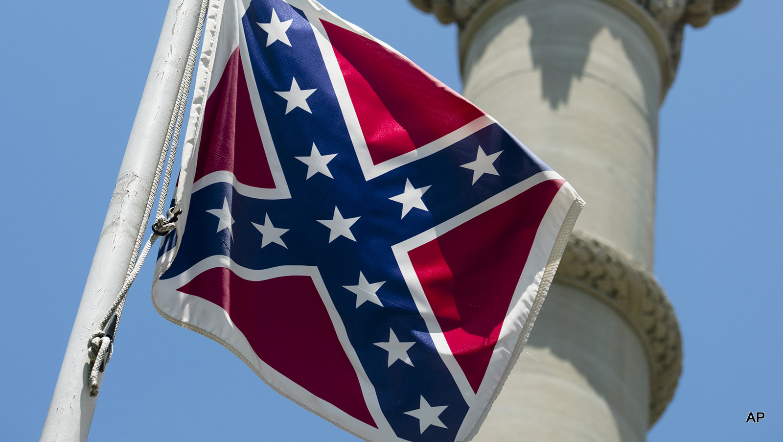 A Confederate flag flies next to the Alabama Confederate Memorial on the grounds of the Alabama Capitol 