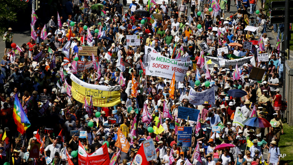 People protest against the upcoming G-7 in Munich, southern Germany, Thursday, June 4, 2015. The summit will take place June 7/8 on Schloss Elmau hotel near Garmisch-Partenkirchen.