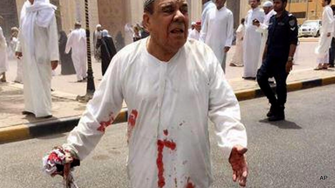 a man in a blood-soaked dishdasha following of a deadly blast at a Shiite mosque in Kuwait City