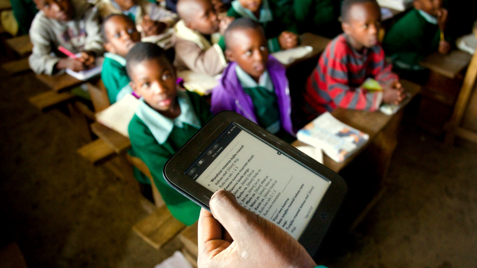 Every lesson is tightly scripted. The teachers deliver lessons by scrolling through the scripts on a tablet. Even small details such as praising students are listed in the class instructions. (Frederic Courbet/NPR)