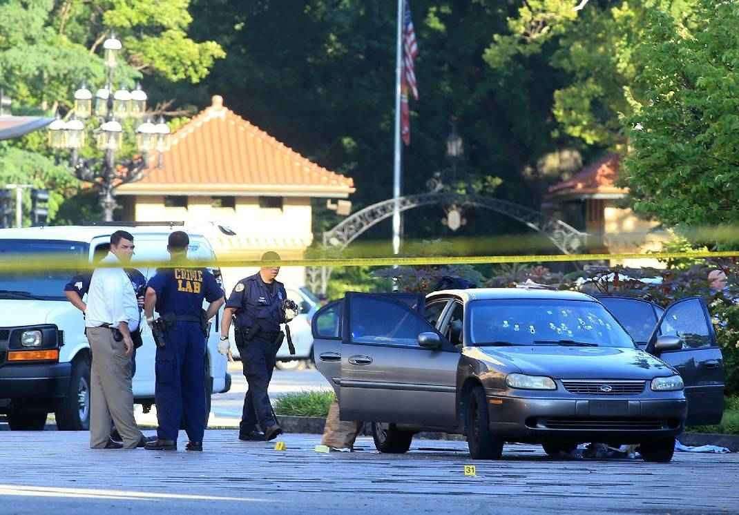 St. Louis police investigate the scene of a shooting where a gunman opened fire on a uniformed St. Louis police sergeant