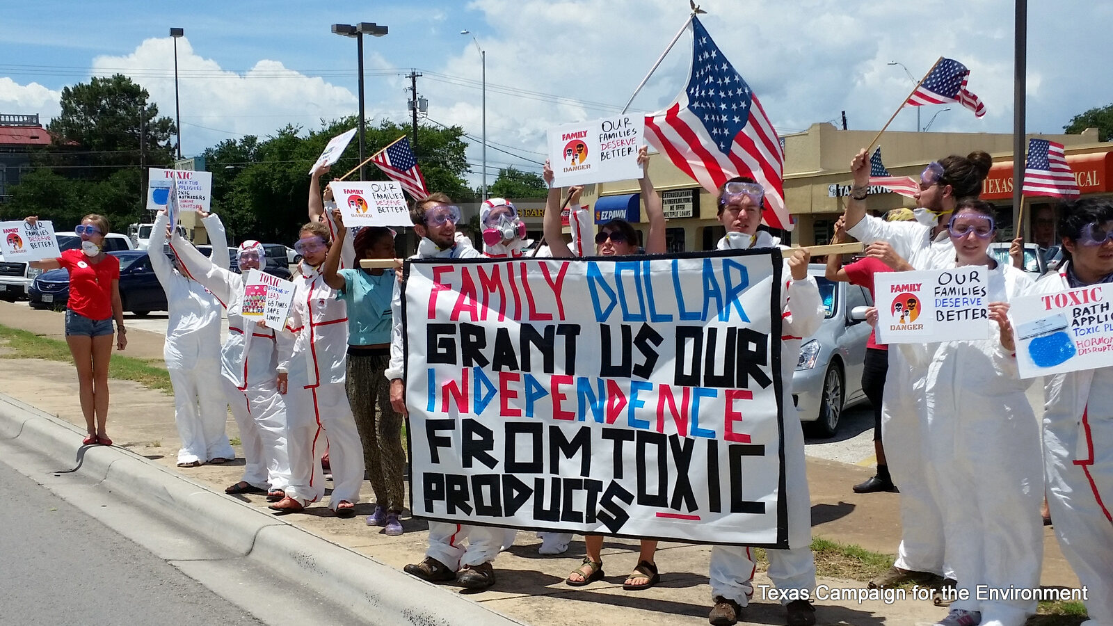 Protesters in hazardous material-handling suits gathered at a Family Dollar discount store in Austin, Texas