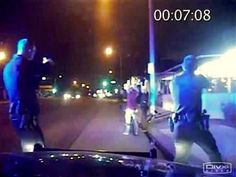 In this June 2, 2013, frame from Gardena Police Department dash-cam video, officers aim their guns at Ricardo Diaz-Zeferino, right, and two friends while investigating a bicycle theft in Gardena, Calif. Moments later police fatally shot Diaz-Zeferino. Hours after a federal judge ordered the release of videos sought by The Associated Press and other news organizations Tuesday, July 14, 2015, a federal appeals court has issued a stay blocking release of the video. (Gardena Police Department)