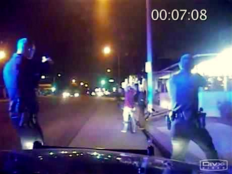 In this June 2, 2013, frame from Gardena Police Department dash-cam video, officers aim their guns at Ricardo Diaz-Zeferino, right, and two friends while investigating a bicycle theft in Gardena, Calif. Moments later police fatally shot Diaz-Zeferino. Hours after a federal judge ordered the release of videos sought by The Associated Press and other news organizations Tuesday, July 14, 2015, a federal appeals court has issued a stay blocking release of the video. (Gardena Police Department)