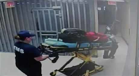 In this July 13, 2015, frame taken from video provided by the Waller County Sheriff's Department from a motion-operated camera, emergency personnel carry a gurney near Sandra Bland's jail cell, at the Waller County jail in Hempstead, Texas. The video, released Monday, July 20, shows there was no activity for about 90 minutes in the hallway leading to the cell where authorities say Bland was found hanged, three days after her arrest. (Waller County Sheriff's Department via AP)