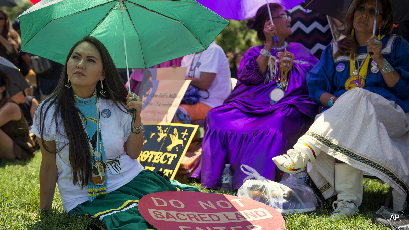 Native American Indians including Noel Altaha, left, of White Mountain Apache tribe, join Apache Stronghold activists in a rally to save Oak Flat, land near Superior, Ariz., sacred to Western Apache tribes, in front of the U.S. Capitol in Washington, Tuesday, July 22, 2015.