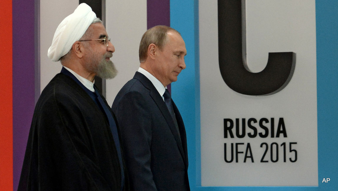 Russian President Vladimir Putin walks with President of the Islamic Republic of Iran Hassan Ruhani, left, in Ufa, Russia, Thursday, July 9, 2015.