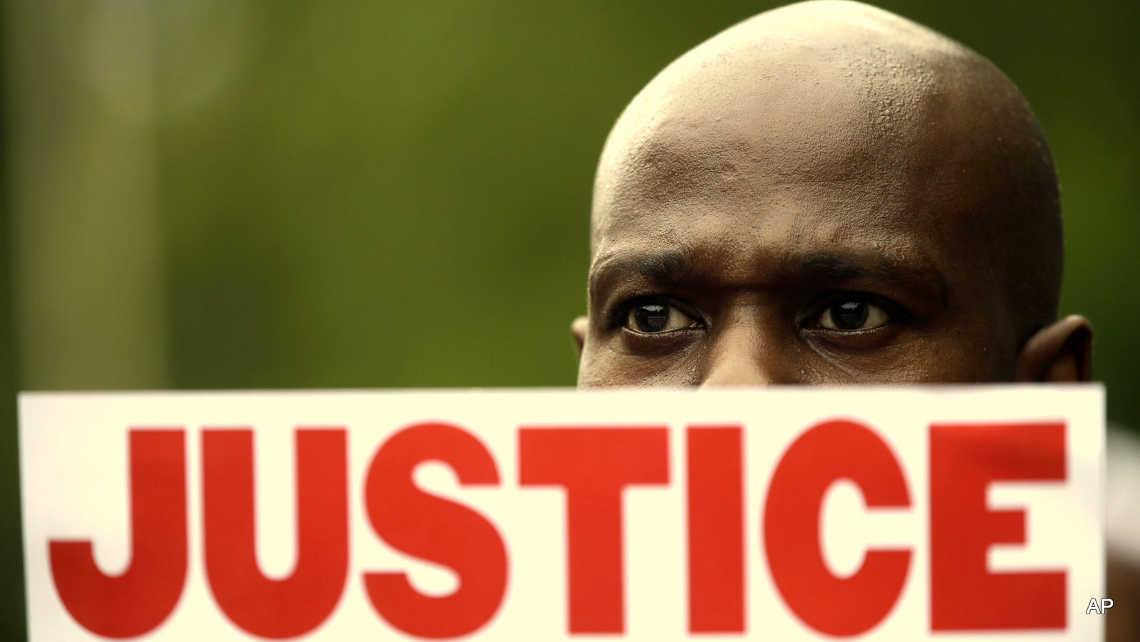A demonstrator holds a sign calling for justice during a rally in New York