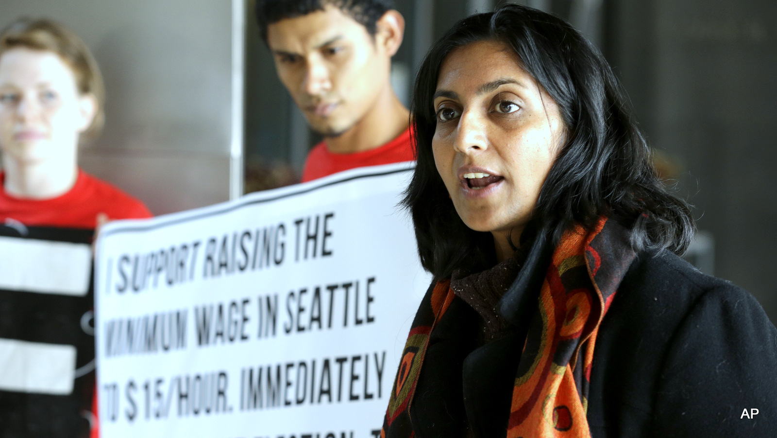 Seattle City Council Kshama Sawant, right, speaks outside City Council chambers in Seattle