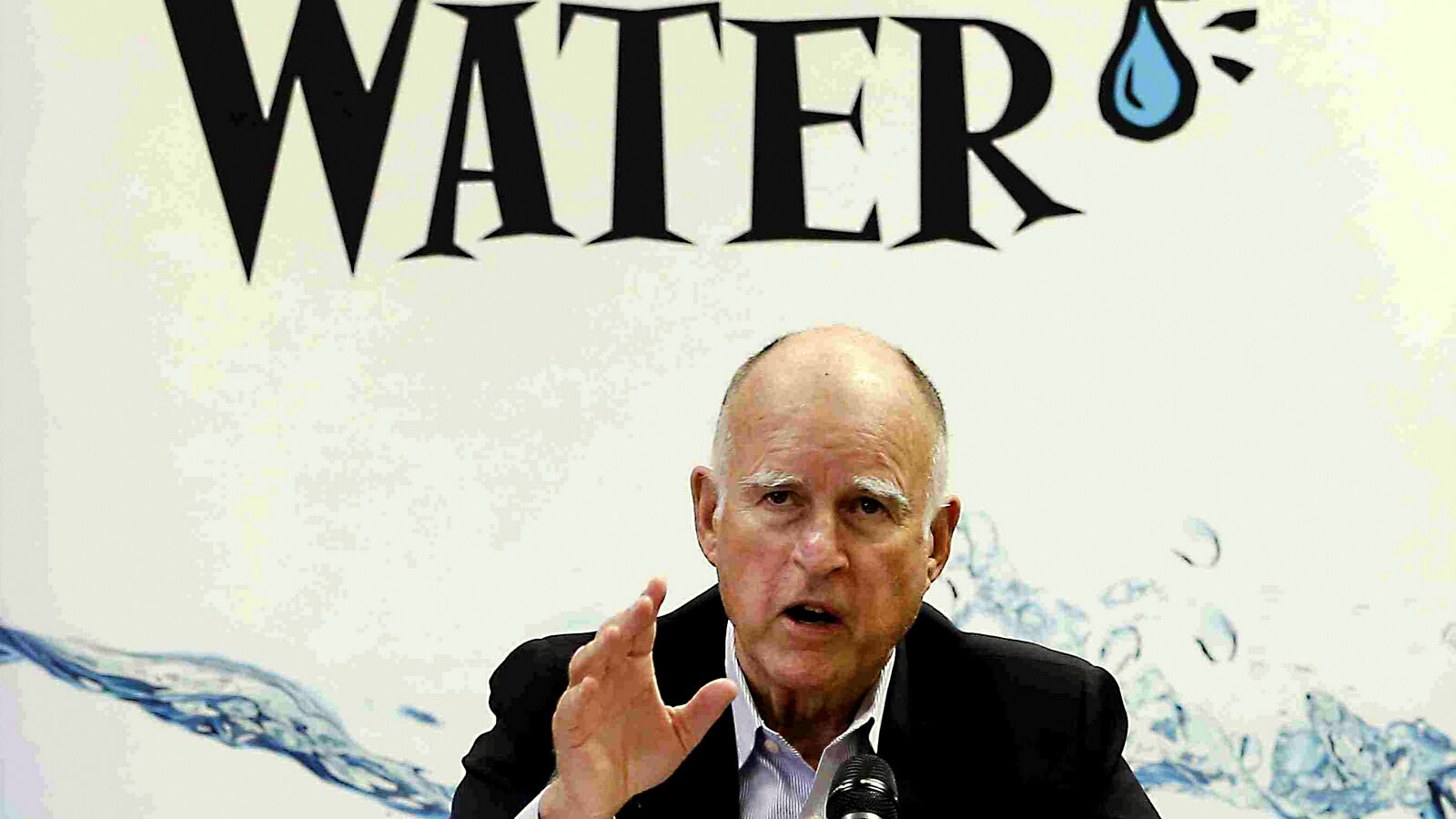 California Gov. Jerry Brown talks with reporters after a meeting about the drought