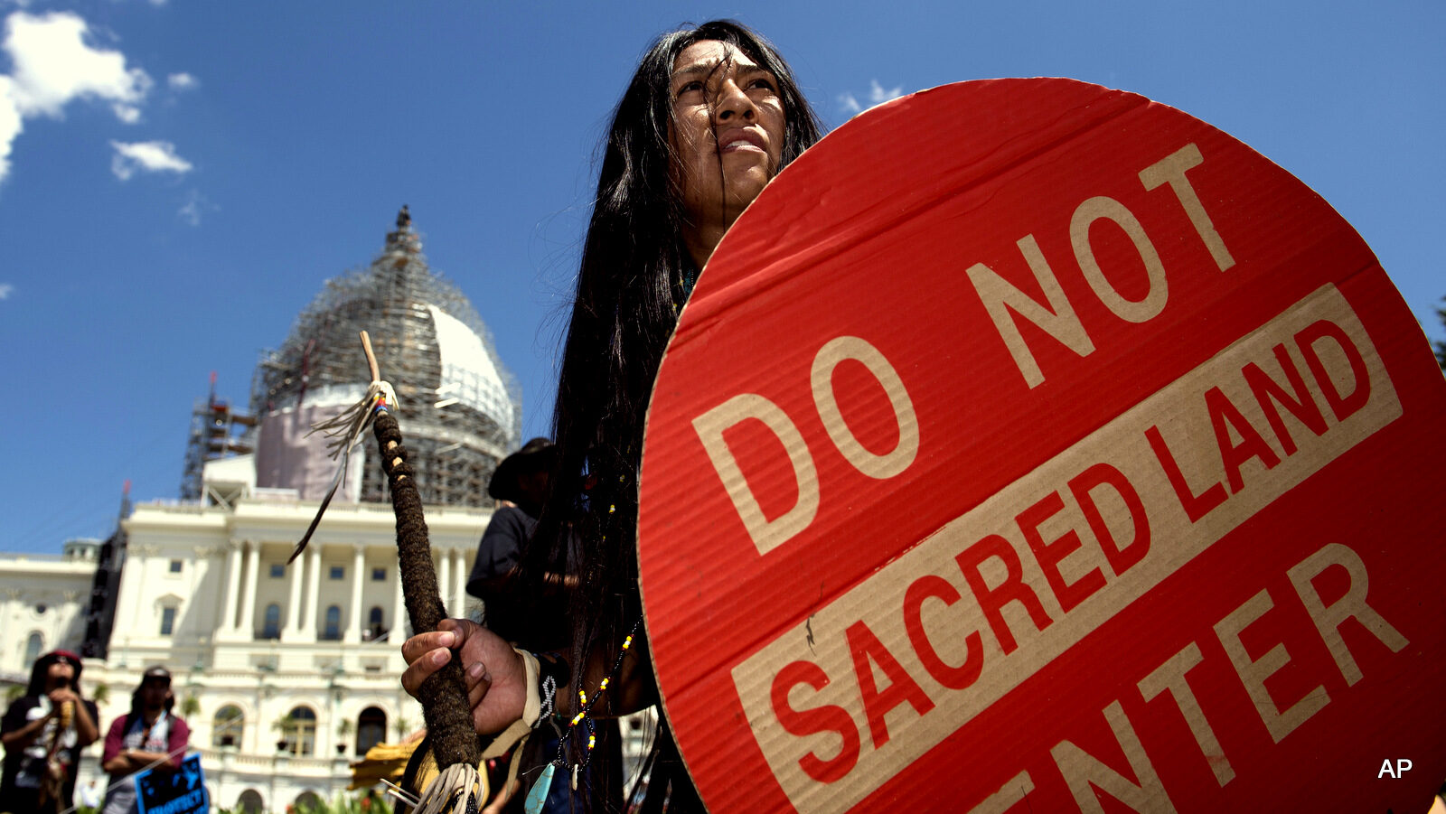 An Apache activist dancer performs in a rally to save Oak Flat, land near Superior, Ariz., sacred to Western Apache tribes, in front of the U.S. Capitol in Washington, Tuesday, July 22, 2015.