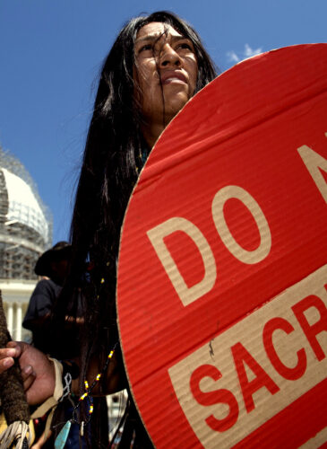 An Apache activist dancer performs in a rally to save Oak Flat, land near Superior, Ariz., sacred to Western Apache tribes, in front of the U.S. Capitol in Washington, Tuesday, July 22, 2015.