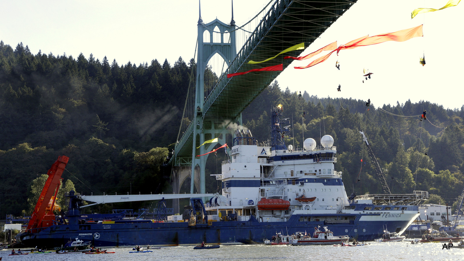 The Royal Dutch Shell PLC icebreaker Fennica heads up the Willamette River under protesters hanging from the St. Johns Bridge on its' way to Alaska in Portland, Ore., Thursday, July 30, 2015.
