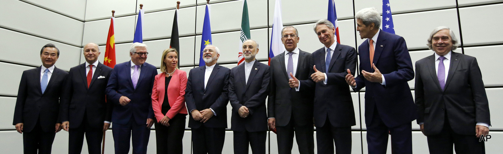 From left to right, Chinese Foreign Minister Wang Yi, French Foreign Minister Laurent Fabius, German Foreign Minister Frank Walter Steinmeier, European Union High Representative for Foreign Affairs and Security Policy Federica Mogherini, Iranian Foreign Minister Mohammad Javad Zarif, Head of the Iranian Atomic Energy Organization Ali Akbar Salehi, Russian Foreign Minister Sergey Lavrov, British Foreign Secretary Philip Hammond, U.S. Secretary of State John Kerry and U.S. Secretary of Energy Ernest Moniz pose for a group picture at the United Nations building in Vienna, Austria Tuesday, July 14, 2015. 