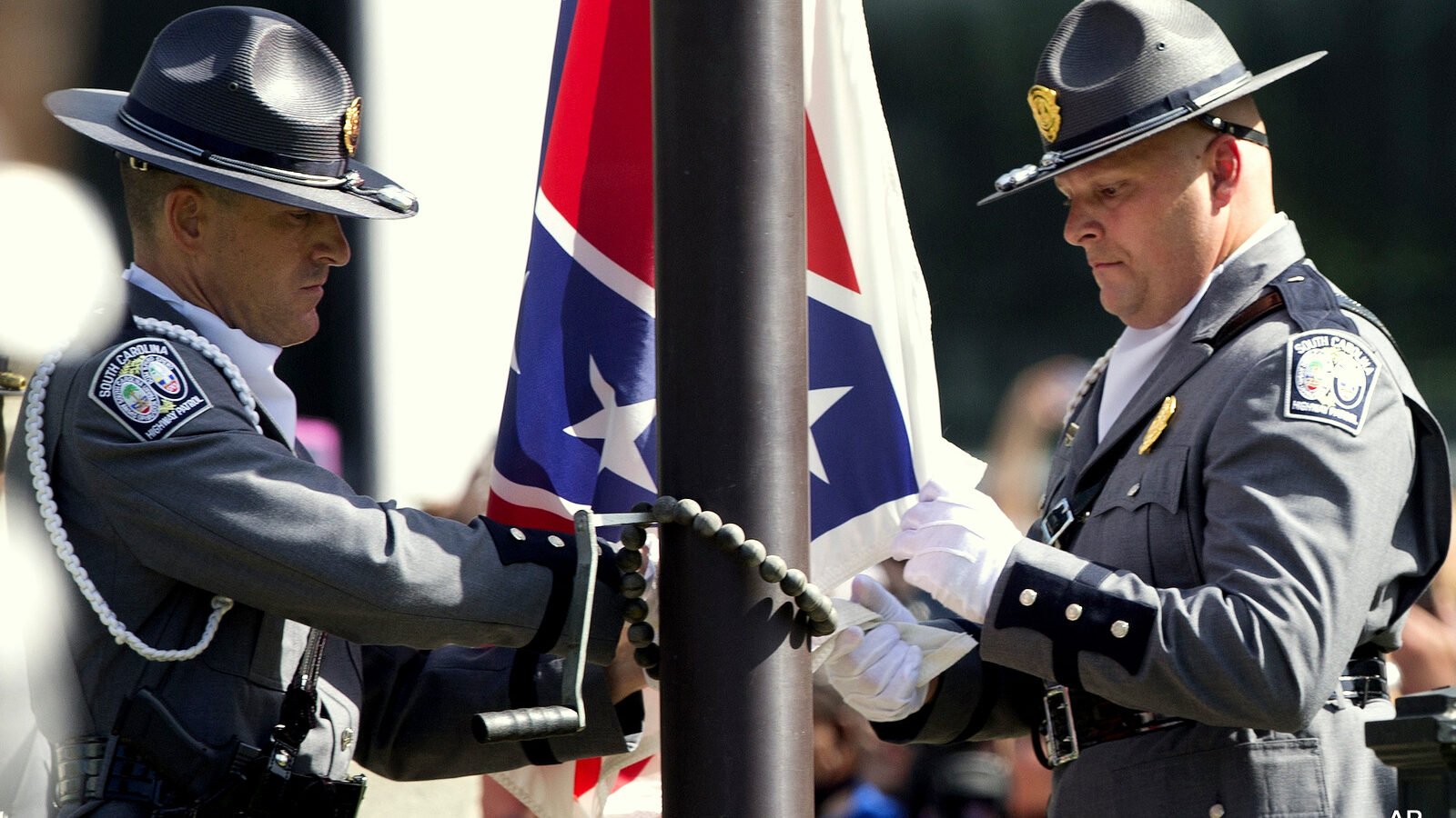 An honor guard from the South Carolina Highway patrol lowers the Confederate battle flag as it is removed from the Capitol grounds Friday