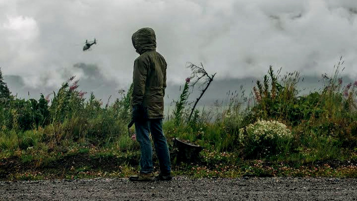 A member of the Unist’ot’en Camp watches as a helicopter affiliated with the pipeline projects lands, and is quickly forced to flee after being confronted by Unist’ot’en residents. (Photo: Unist’ot’en Facebook Page)