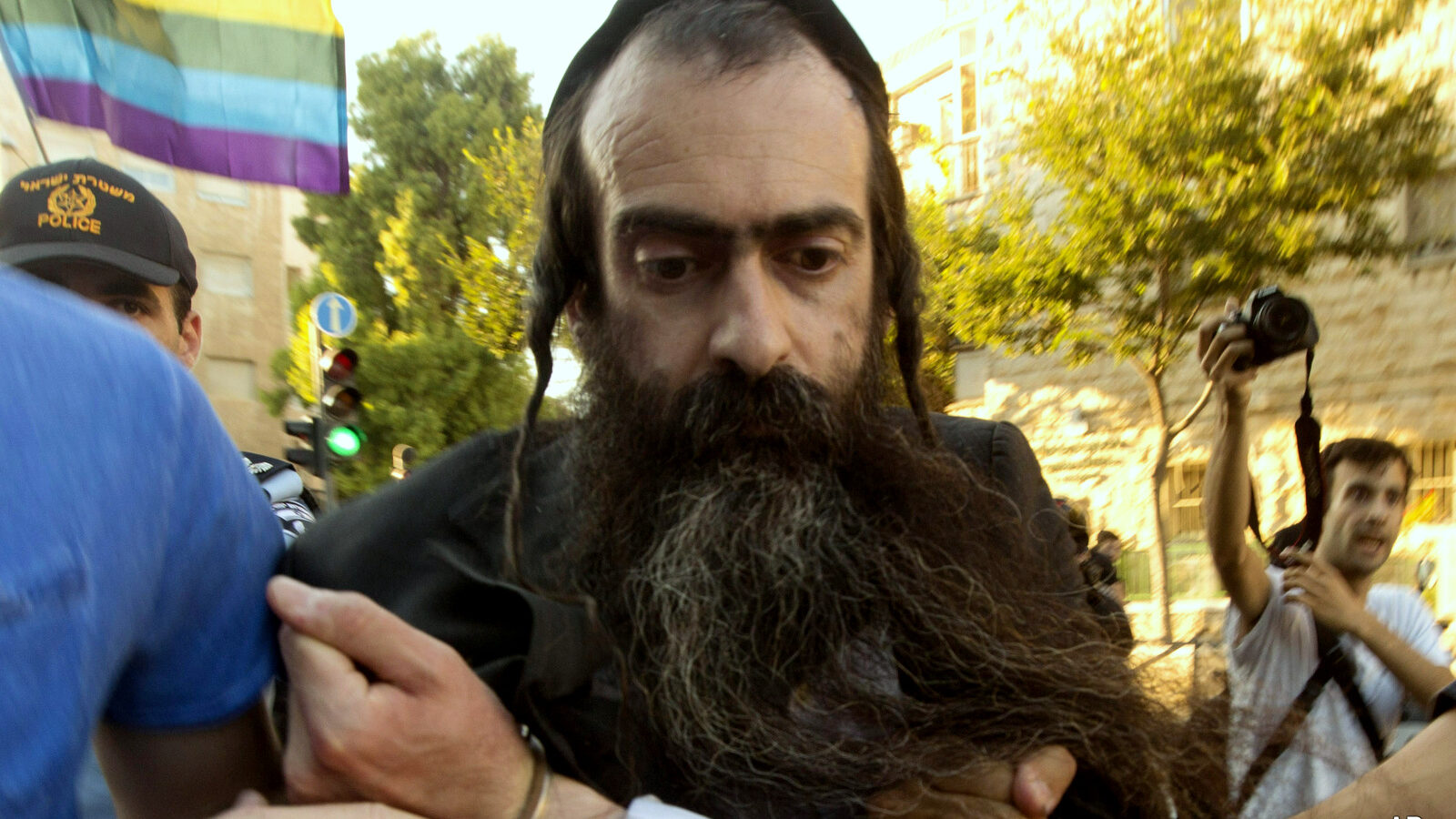 Ultra Orthodox Jew Yishai Schlissel is detained by plain-clothes police officers after he stabbed people during a gay pride parade in Jerusalem on Thursday, July 30, 2015. Schlisse was recently released from prison after serving a term for stabbing several people at a gay pride parade in 2005, a police spokeswoman said.