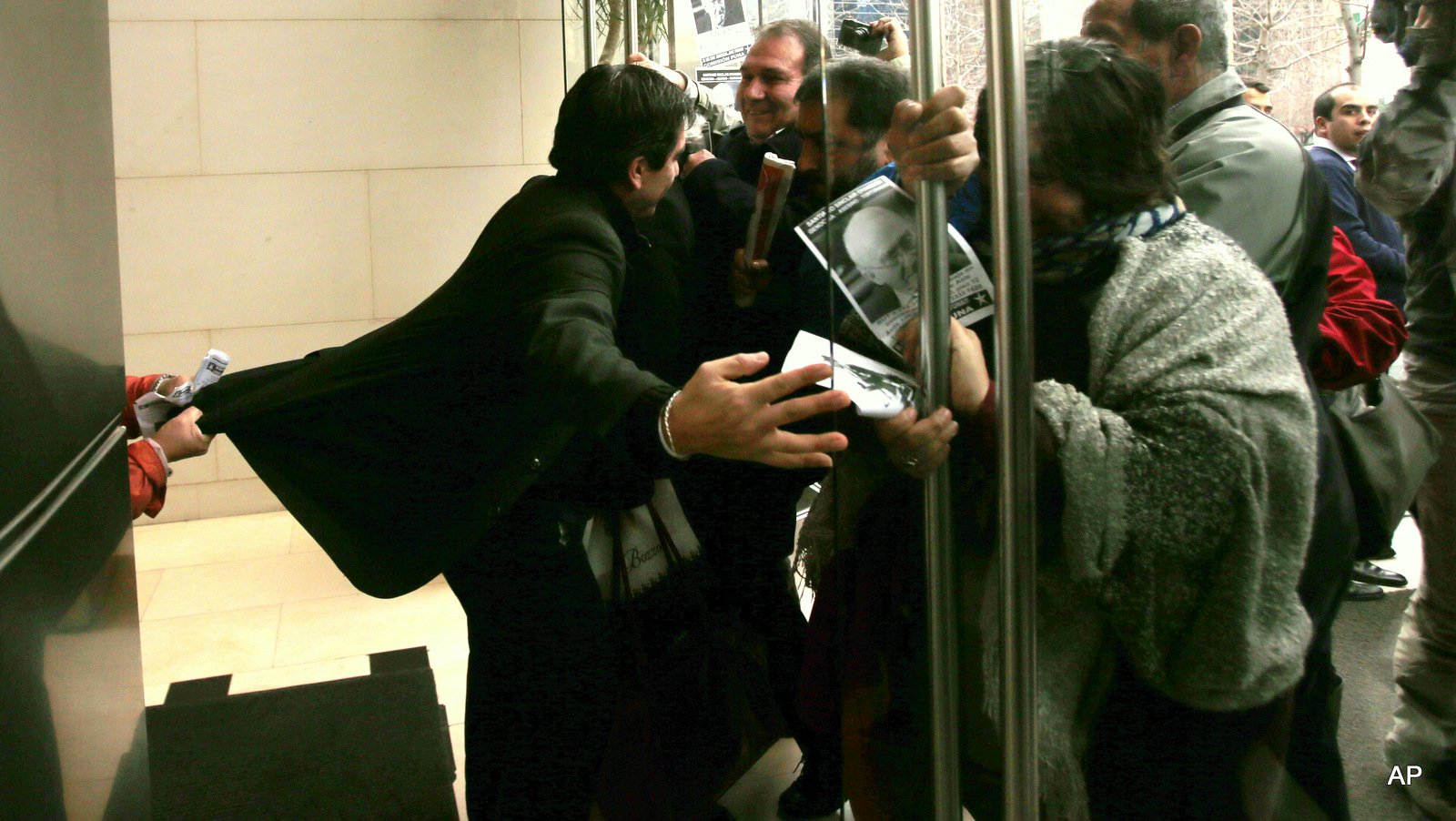 A group protests at the entrance of the office of former army General Santiago Sinclair