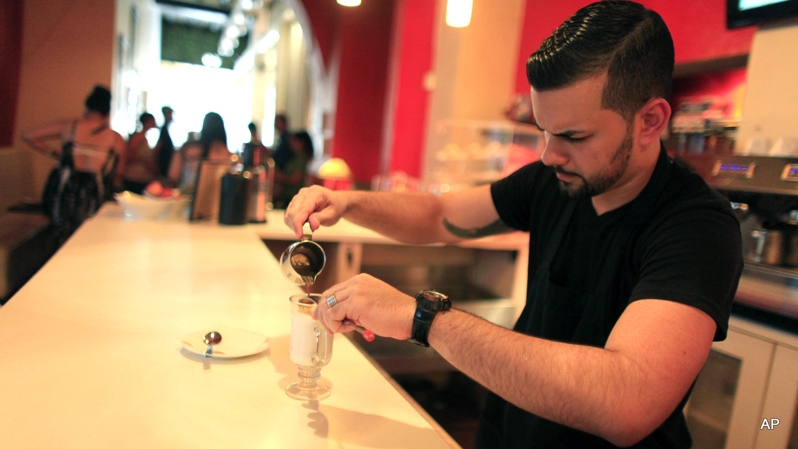 Walter Martin prepares a coffee in his coffee shop in the colonial district of Old San Juan, Puerto Rico