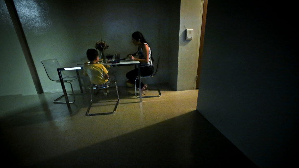 A women sits with her son for dinner in their new sparsely furnished apartment, Thursday, Aug. 13, 2015, in New York. After leaving her husband who beat her for years, she and her little boy spent the next three years homeless because she couldn’t afford New York City rents. About one third of American children are now living in poverty. (AP Photo/Bebeto Matthews)