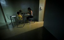 A women sits with her son for dinner in their new sparsely furnished apartment, Thursday, Aug. 13, 2015, in New York. After leaving her husband who beat her for years, she and her little boy spent the next three years homeless because she couldn’t afford New York City rents. About one third of American children are now living in poverty. (AP Photo/Bebeto Matthews)