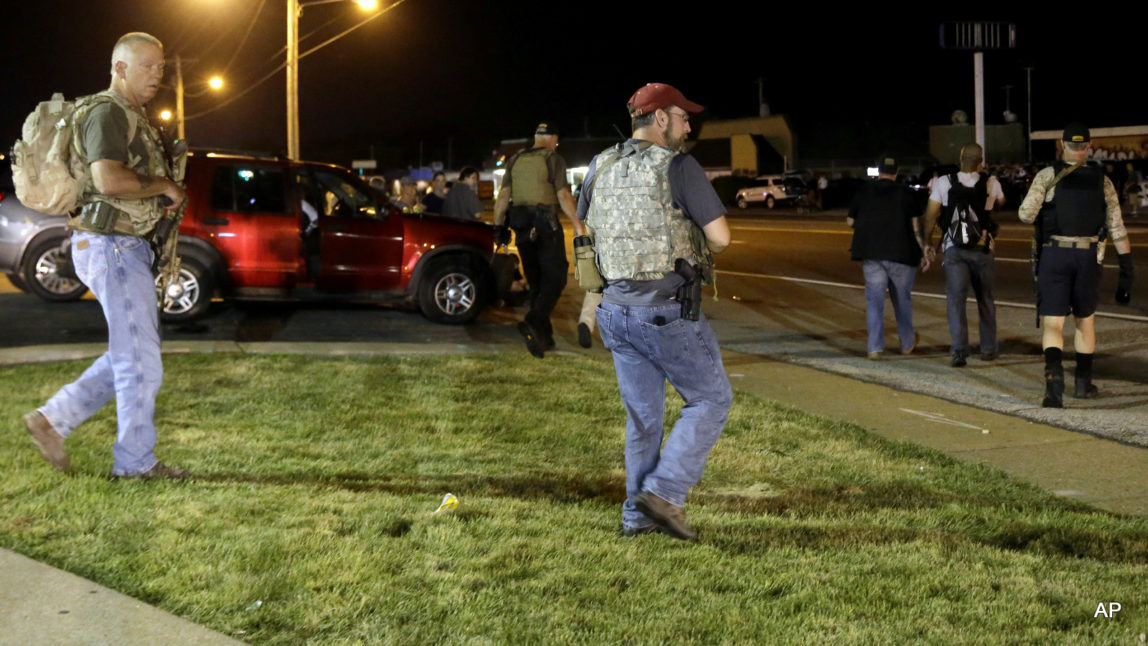 Heavily armed civilians with a group known as the Oath Keepers arrive in Ferguson, Mo., early Tuesday, Aug. 11, 2015. The far-right anti-government activists, largely consists of past and present members of the military, first responders and police officers. St. Louis County Police Chief Jon Belmar said the overnight presence of the militia group, wearing camouflage bulletproof vests and openly carrying rifles and pistols on West Florissant Avenue, the hub of marches and protests for the past several days, was "both unnecessary and inflammatory."