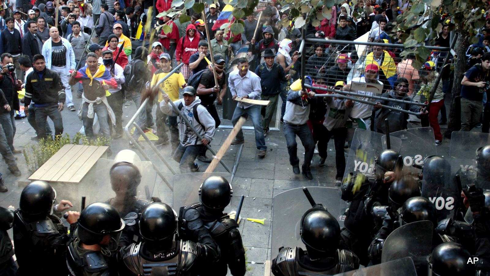 Protesters clash with police near the government palace in Quito, Ecuador