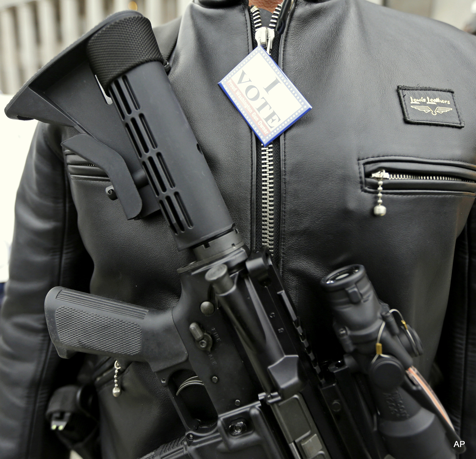 A Colt M4 gun and a button that reads "I Vote - Proud Washington Gun Owner."