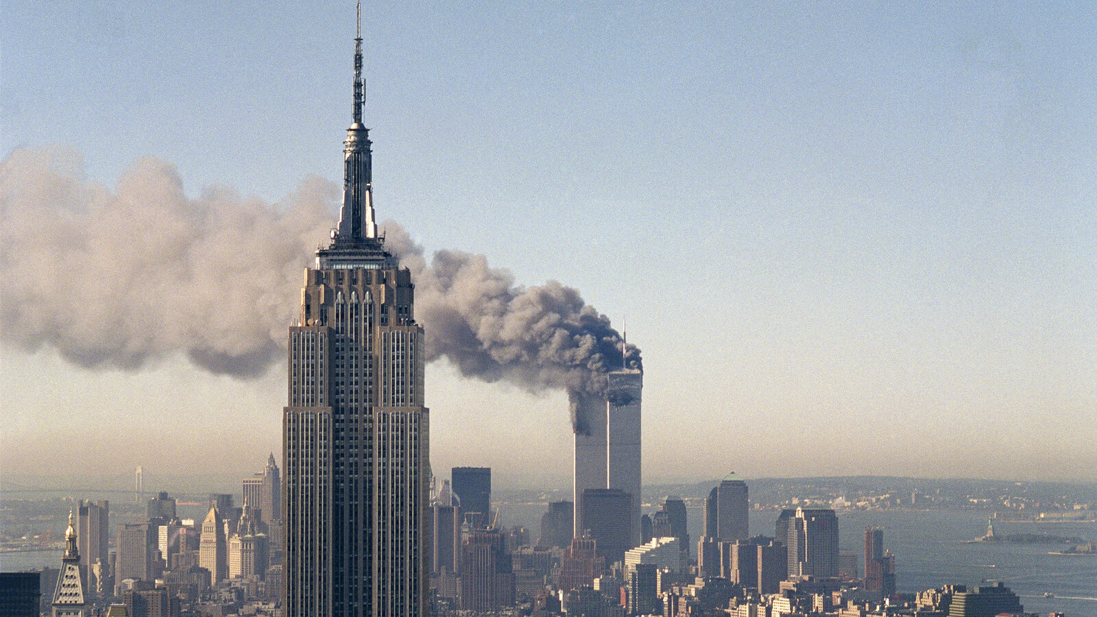 The twin towers of the World Trade Center burn behind the Empire State Building in New York.(AP Photo/Marty Lederhandler)