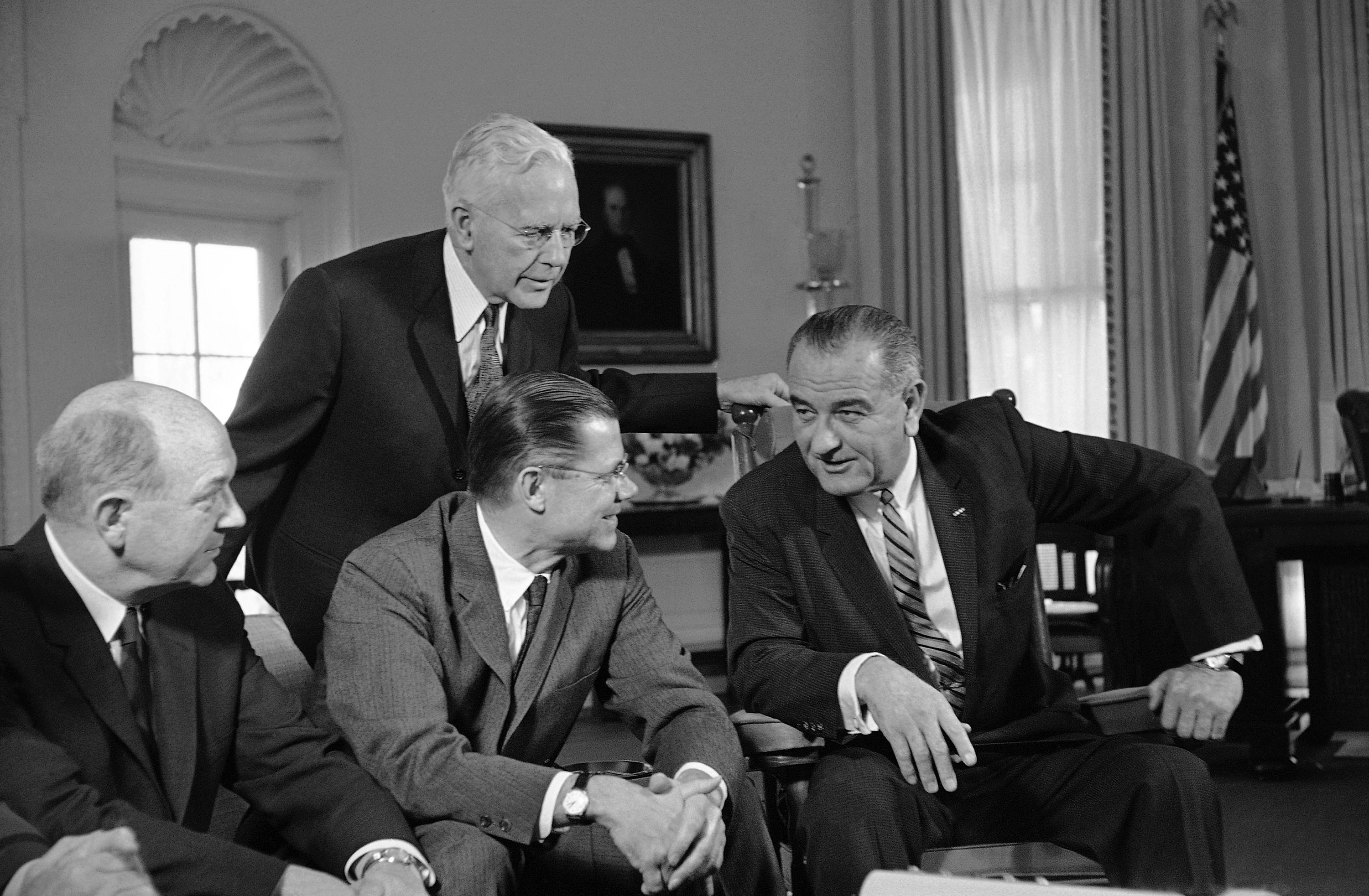 In this March 13, 1964 file photo, President Lyndon Johnson, right, talks with Secretary of Defense Robert McNamara, center sitting, after McNamara returned from a fact-finding trip to South Vietnam, at the White House in Washington. Fifty years ago Sunday, Aug. 10, 2014, reacting to reports of a U.S. Navy encounter with enemy warships in the Gulf of Tonkin off Vietnam, reports long since discredited, Johnson signed a resolution passed overwhelmingly by Congress that historians call the crucial catalyst for deep American involvement in the Vietnam War. (AP Photo/File)