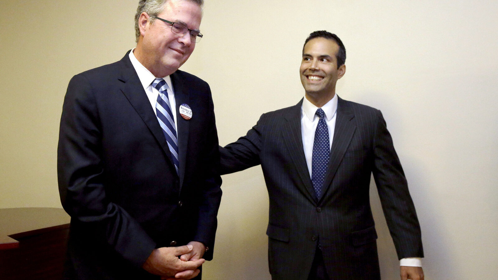 File - In this Oct. 4, 2014 file photo, George P. Bush, right, reaches to his father former Florida Gov. Jeb Bush after the senior Bush became emotional when expressing his pride for his son while speaking to supporters at Hardin-Simmons University, in Abilene, Texas. George P. Bush has been helping members of his famous family get elected since age 3 but has never played a larger role as a political surrogate than this cycle, as he tries to help his dad follow his grandfather, George H.W. Bush, and his uncle, George W. Bush, to the White House. (AP Photo/LM Otero, File)