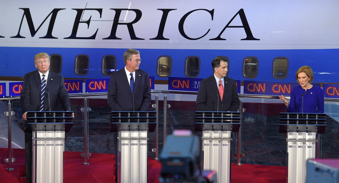 Republican presidential candidate, businesswoman Carly Fiorina, right, speaks as, from left, Donald Trump, Jeb Bush, and Scott Walker look on during the CNN Republican presidential debate at the Ronald Reagan Presidential Library and Museum on Wednesday, Sept. 16, 2015, in Simi Valley, Calif. (AP Photo/Mark J. Terrill)